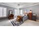 Bright bedroom with large windows, a ceiling fan, neutral carpet, and traditional-style furnishings at 195 High Bluff Ct, Duluth, GA 30097