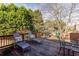 Outdoor deck with lounge chairs, BBQ grill and an outdoor dining area overlooking lush trees at 195 High Bluff Ct, Duluth, GA 30097