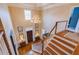 Grand foyer boasts a soaring ceiling, elegant chandelier, hardwood floors, and a staircase with white risers at 195 High Bluff Ct, Duluth, GA 30097