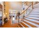 Spacious foyer with hardwood floors, grand staircase, and views into adjacent living spaces at 195 High Bluff Ct, Duluth, GA 30097