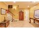 Welcoming hallway with wood armoire, white stairs, and tile flooring creates a warm ambiance at 195 High Bluff Ct, Duluth, GA 30097