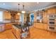 Bright kitchen featuring an island with barstools, wooden cabinetry, and hardwood floors at 195 High Bluff Ct, Duluth, GA 30097