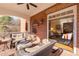 Inviting covered porch featuring wicker seating and a ceiling fan, perfect for outdoor relaxation with brick walls at 195 High Bluff Ct, Duluth, GA 30097