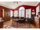 Sitting room featuring red walls, high ceilings, hardwood floors, an area rug, and a leather sofa at 195 High Bluff Ct, Duluth, GA 30097