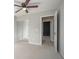 Neutral bedroom with ceiling fan, mirrored closet doors, and an en-suite bathroom at 5545 Mountain Top Pl, Cumming, GA 30041