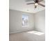 Bedroom with neutral carpeting, ceiling fan, and lots of natural light at 5545 Mountain Top Pl, Cumming, GA 30041