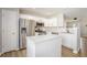 Well-lit kitchen with white cabinets, stainless steel appliances, and an island at 5545 Mountain Top Pl, Cumming, GA 30041