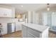 A well-lit kitchen features stainless steel appliances, island, and sliding glass doors at 5545 Mountain Top Pl, Cumming, GA 30041