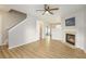 Cozy living room featuring a classic fireplace, hardwood flooring, and staircase to the second floor at 5545 Mountain Top Pl, Cumming, GA 30041