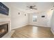 Bright living room featuring hardwood floors, a fireplace, and neutral paint at 5545 Mountain Top Pl, Cumming, GA 30041