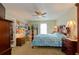 Comfortable bedroom with a ceiling fan, natural light, and classic furnishings, including a four-poster bed at 1088 Raleigh Way, Lawrenceville, GA 30043