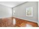 Bright bedroom with hardwood floors, natural light, and neutral paint at 1549 Beecher Sw St, Atlanta, GA 30310