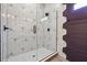 Elegant shower with geometric tile and dark accent wall at 1549 Beecher Sw St, Atlanta, GA 30310