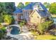 Stunning backyard featuring a pool, spa, tiered deck, and lush landscaping, perfect for outdoor entertaining at 2654 Nutwood Trce, Duluth, GA 30097