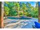 Backyard pool surrounded by lush greenery and palm trees, complete with a relaxing waterfall feature at 2654 Nutwood Trce, Duluth, GA 30097