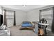 Bedroom featuring a gray carpet, a bed, and a desk at 3990 N Quail Dr, Douglasville, GA 30135