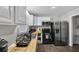 A kitchen featuring a stainless steel refrigerator and a butcher block countertop with white cabinets at 3990 N Quail Dr, Douglasville, GA 30135