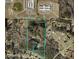 Aerial view showcasing property boundaries with wooded areas and nearby community features at 744 Hampton Locust Grove Rd, Hampton, GA 30228