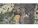 Aerial view of a house with a pool next to a tree-lined pond within a wooded area at 744 Hampton Locust Grove Rd, Hampton, GA 30228