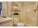 Bathroom featuring a shower and toilet with a metal shelving unit for storage at 744 Hampton Locust Grove Rd, Hampton, GA 30228