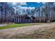 View of a stately two-story brick home featuring large white columns and mature trees at 744 Hampton Locust Grove Rd, Hampton, GA 30228