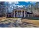 Traditional two-story brick home featuring a prominent portico and large front yard at 744 Hampton Locust Grove Rd, Hampton, GA 30228