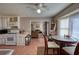 Inviting kitchen with white cabinetry, tile flooring, and view to an adjacent living area at 744 Hampton Locust Grove Rd, Hampton, GA 30228