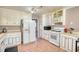 Spacious kitchen with white cabinetry, tile floor, and modern appliances at 744 Hampton Locust Grove Rd, Hampton, GA 30228