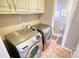 Laundry room featuring a side-by-side washer and dryer and pink tile floors at 744 Hampton Locust Grove Rd, Hampton, GA 30228