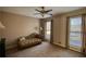 Comfortable living room with neutral tones, sofa, and natural light from large windows at 744 Hampton Locust Grove Rd, Hampton, GA 30228