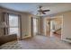 Cozy living room featuring neutral carpet, multiple windows, and access to other living areas at 744 Hampton Locust Grove Rd, Hampton, GA 30228