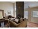 Bright living room with a floor-to-ceiling stone fireplace and large windows at 744 Hampton Locust Grove Rd, Hampton, GA 30228