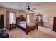 Relaxing main bedroom features a ceiling fan, carpet and ample closet space at 744 Hampton Locust Grove Rd, Hampton, GA 30228