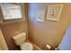 Powder room featuring a toilet, artwork, and blinds at 744 Hampton Locust Grove Rd, Hampton, GA 30228