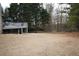 Expansive backyard with a wooden deck overlooking the lawn, and mature trees providing privacy at 1365 Willis Lake Dr, Kennesaw, GA 30152