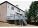 Exterior view of a home featuring a deck overlooking the expansive backyard and mature trees at 1365 Willis Lake Dr, Kennesaw, GA 30152