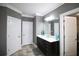 Bright bathroom with a double sink vanity, large mirror, and storage cabinets at 1365 Willis Lake Dr, Kennesaw, GA 30152