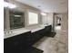 Bathroom featuring dual sinks with granite countertops and framed mirrors, with access to glass shower at 1365 Willis Lake Dr, Kennesaw, GA 30152
