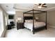 Primary bedroom with four-poster bed, recessed ceiling, fireplace and desk with an office chair at 1365 Willis Lake Dr, Kennesaw, GA 30152