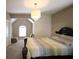 Bedroom featuring a dark wood bed frame, chandelier and a seating area by a window at 1365 Willis Lake Dr, Kennesaw, GA 30152