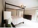 Bedroom with a dark wood four poster bed frame, carpeting and and dressers at 1365 Willis Lake Dr, Kennesaw, GA 30152