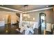 Elegant dining room with a modern chandelier, large windows, and wainscoting at 1365 Willis Lake Dr, Kennesaw, GA 30152
