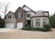 Charming two-story brick home with a well-maintained lawn and manicured landscaping at 1365 Willis Lake Dr, Kennesaw, GA 30152