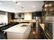 Kitchen featuring a large island with cooktop, modern pendant lighting, and stainless appliances at 1365 Willis Lake Dr, Kennesaw, GA 30152