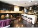 Spacious kitchen with dark cabinets, granite countertops, stainless steel appliances and large island with seating at 1365 Willis Lake Dr, Kennesaw, GA 30152