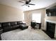 Spacious living room featuring a ceiling fan, fireplace, and adjacent workspace with natural lighting at 1365 Willis Lake Dr, Kennesaw, GA 30152