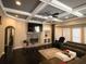 Comfortable living room featuring a stone fireplace, coffered ceilings, and built-in shelving at 1365 Willis Lake Dr, Kennesaw, GA 30152