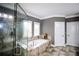 Relaxing main bathroom with a separate shower and soaking tub beneath bright windows at 1365 Willis Lake Dr, Kennesaw, GA 30152