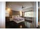 Beautiful bedroom with tray ceilings, wood accent wall, lots of natural light, and a ceiling fan at 1365 Willis Lake Dr, Kennesaw, GA 30152