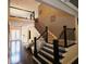 Elegant staircase with dark wood railings and bright foyer at 1365 Willis Lake Dr, Kennesaw, GA 30152